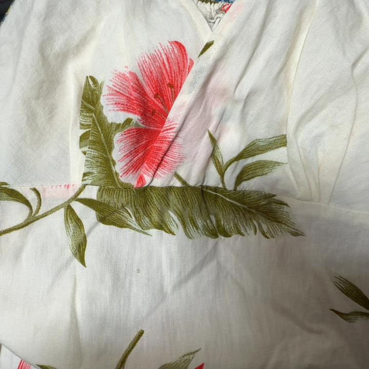 SilkRoll cream floral wrap dress back view displaying the flattering wrap style and knee-length cut