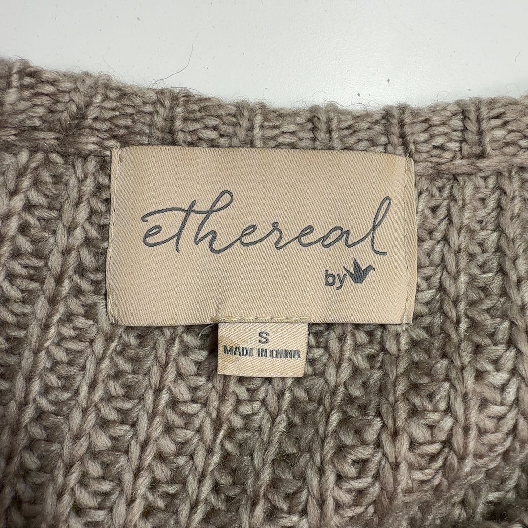 Tag view of beige textured knit vest showing full-length zipper and sleeveless design