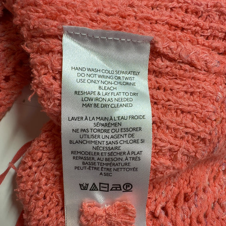 Coral knit tank top with textured pattern and scalloped hem, back view on model