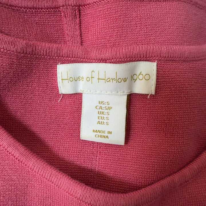 Pink cropped sleeveless knit tank top from House of Harlow 1960, back view on model