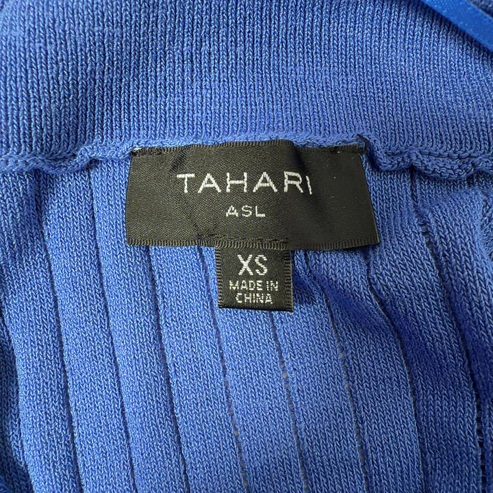 Blue ribbed knit button-up cardigan with notch collar and short sleeves, back view