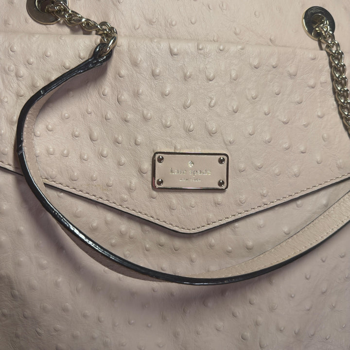 Tag view of cream quilted Kate Spade shoulder tote showing structured design and side pocket detail