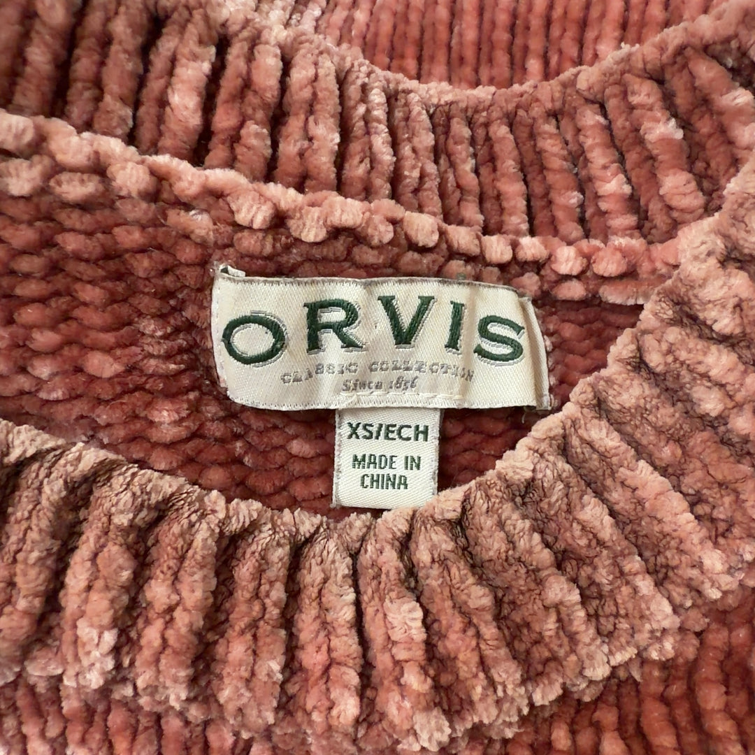 Rust ribbed knit pullover sweater with flared hem and long sleeves, back view