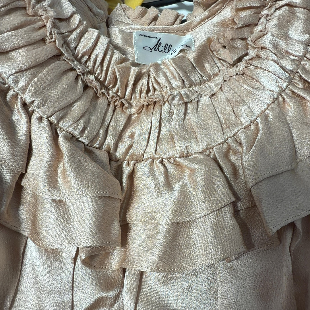 Cream sleeveless blouse with ruffled neckline by Milly, back view