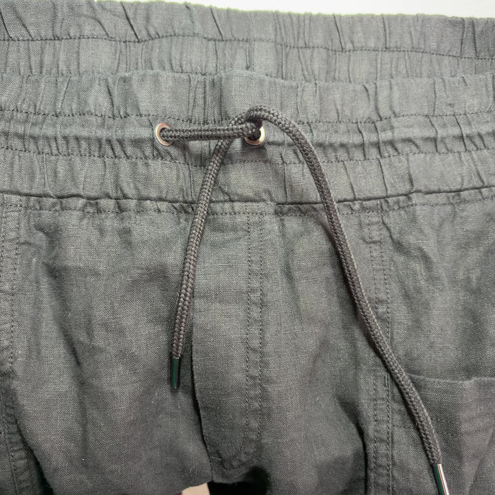 Black drawstring athletic shorts with functional pockets, back view