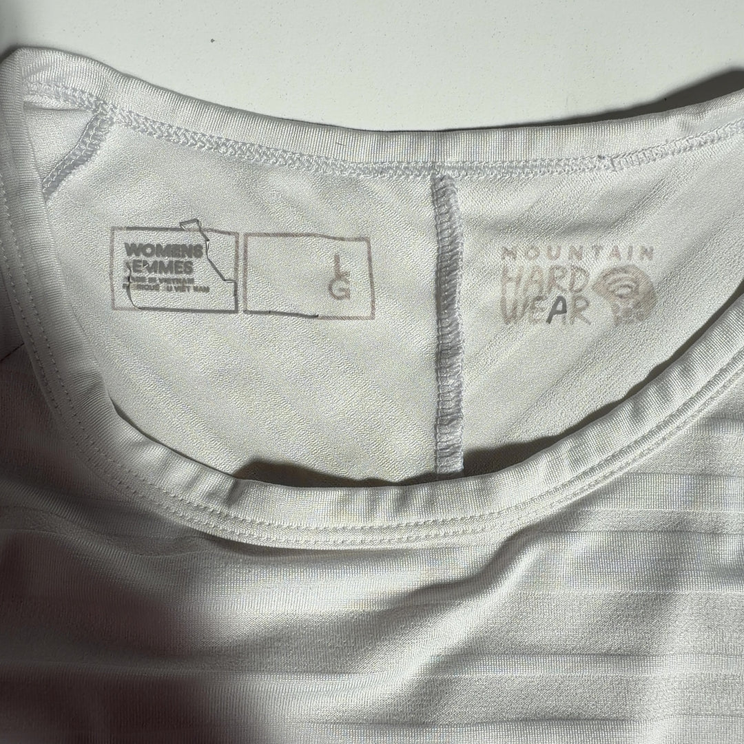 Cream long sleeve athletic top with side vents, back view on model