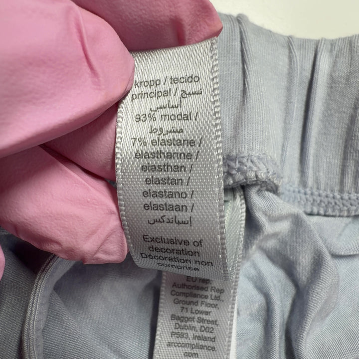 Gray wide leg pants back view, showing relaxed fit and draping silhouette