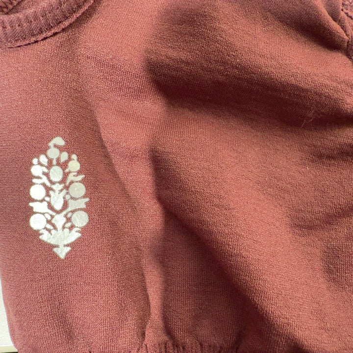 Tag view of burgundy ribbed sports bra tank top showing supportive construction and fit