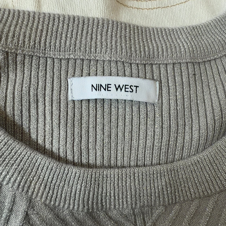 Tag view of cream ribbed knit sweater showing vertical ribbed pattern and fitted silhouette