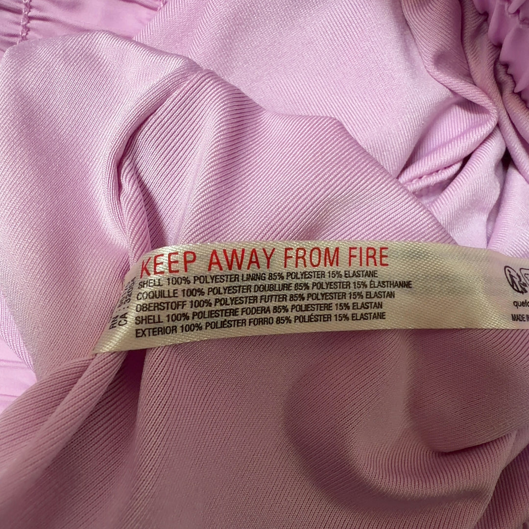 Pink pleated athletic skirt back view, showing voluminous silhouette and fit
