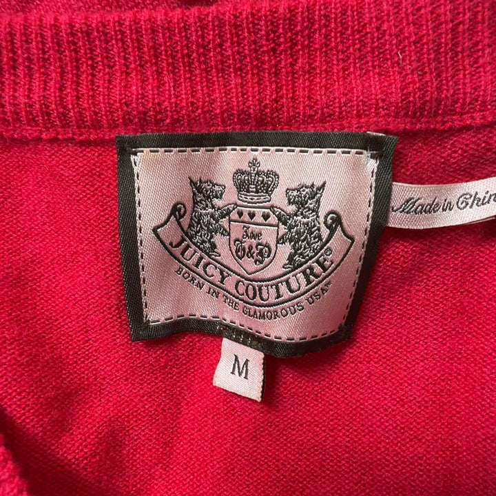 Red cashmere blend cardigan back view showing button closure and ruffle hem detail