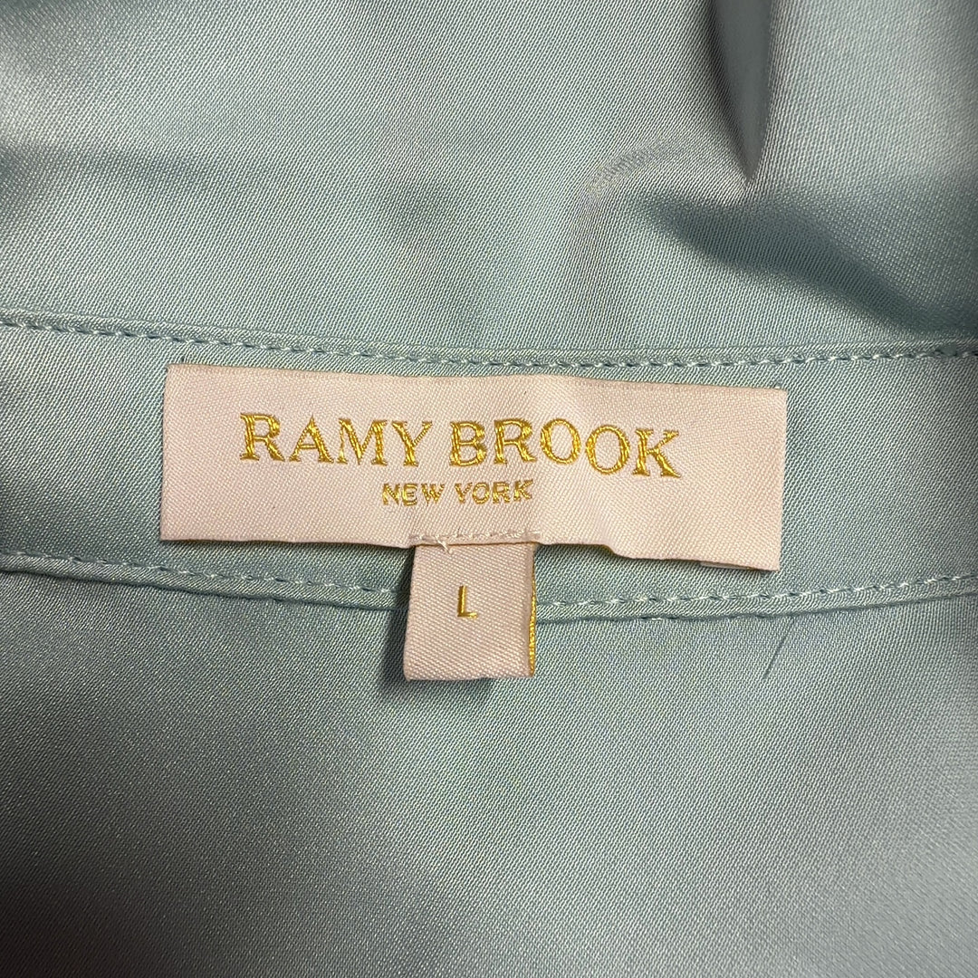 Tag view of blue puff sleeve blouse showing relaxed fit and voluminous sleeve design