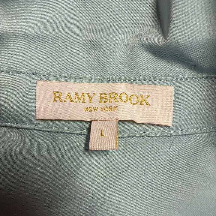Tag view of blue puff sleeve blouse showing relaxed fit and voluminous sleeve design