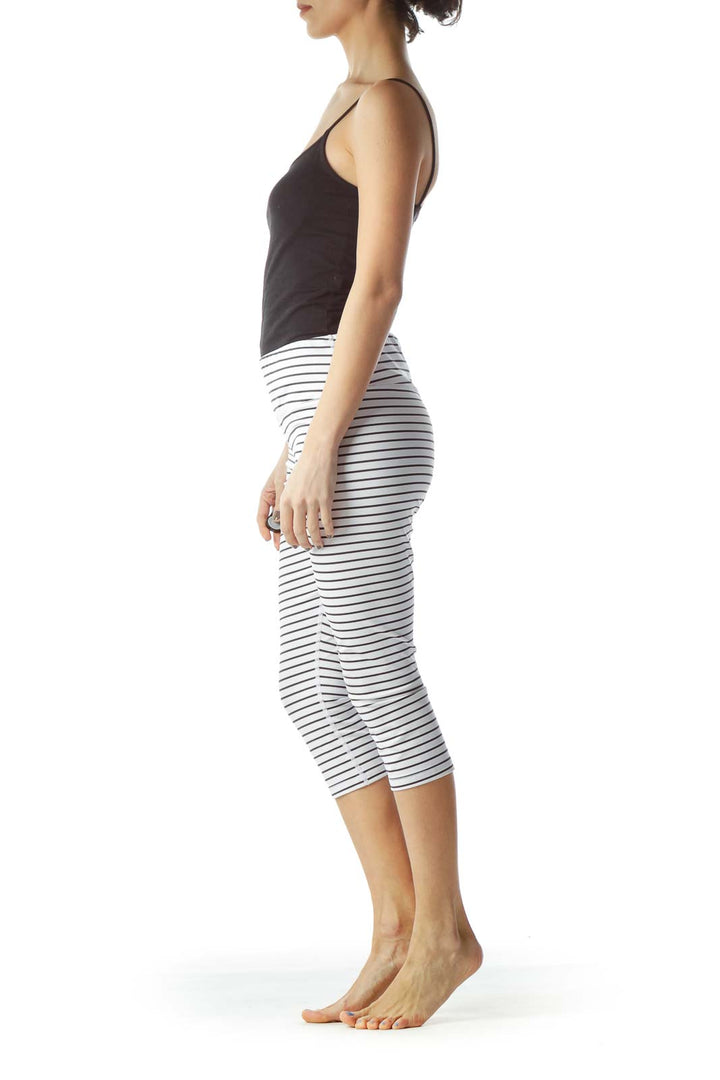 Front view of Scorpio Sol white striped capri leggings