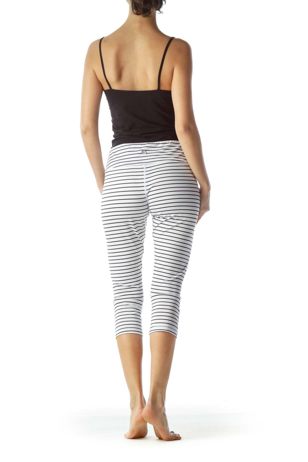 Back view of Scorpio Sol white striped capri leggings on model