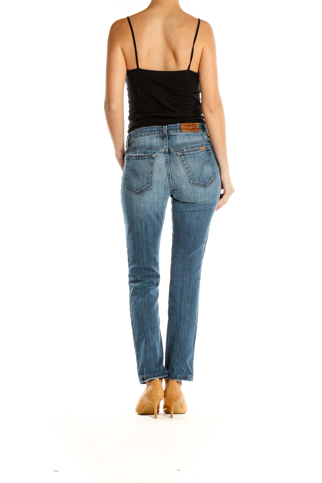 Side view of Joe's blue distressed straight leg jeans on model