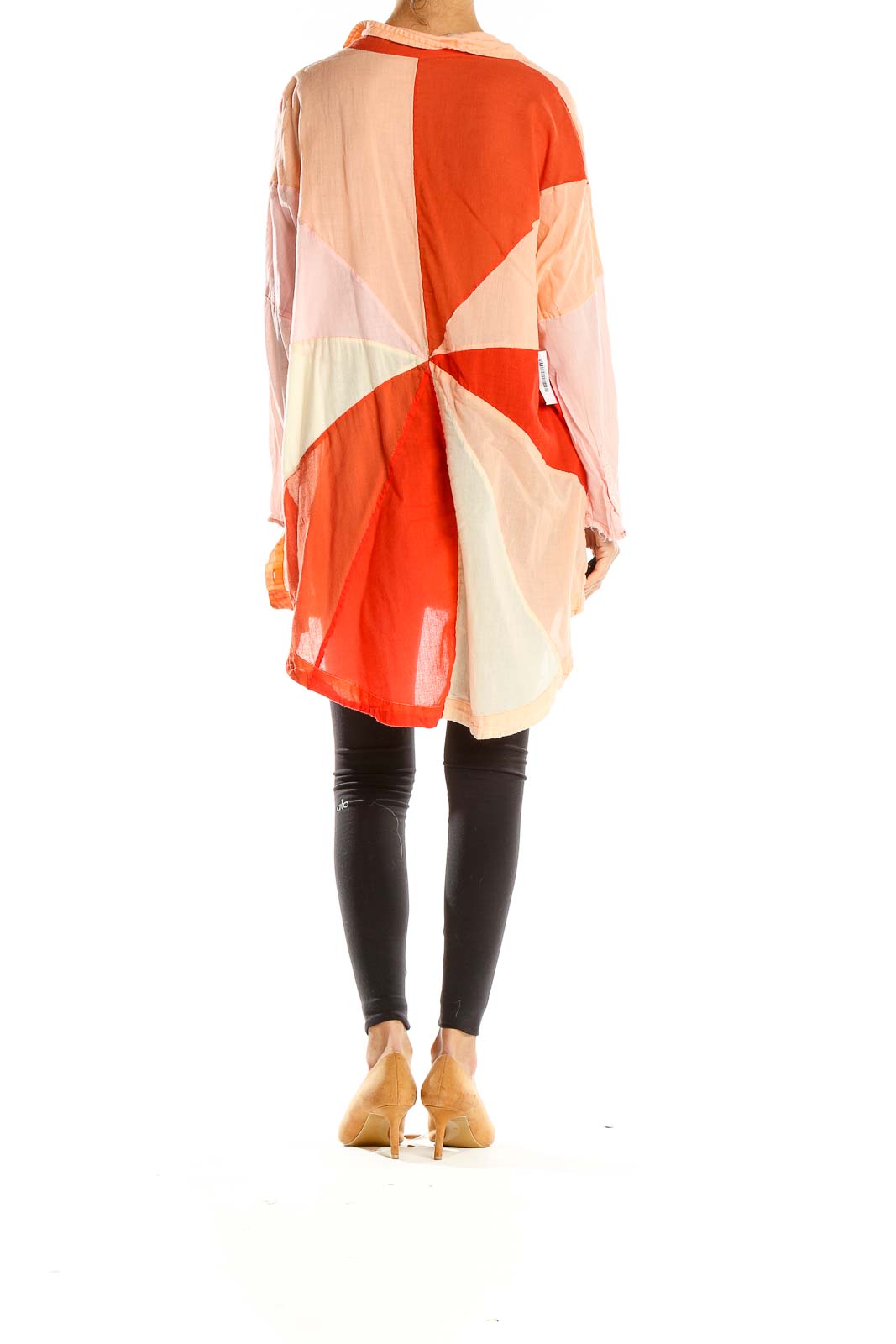 Back view of Free People shirt showcasing orange and peach geometric color block design