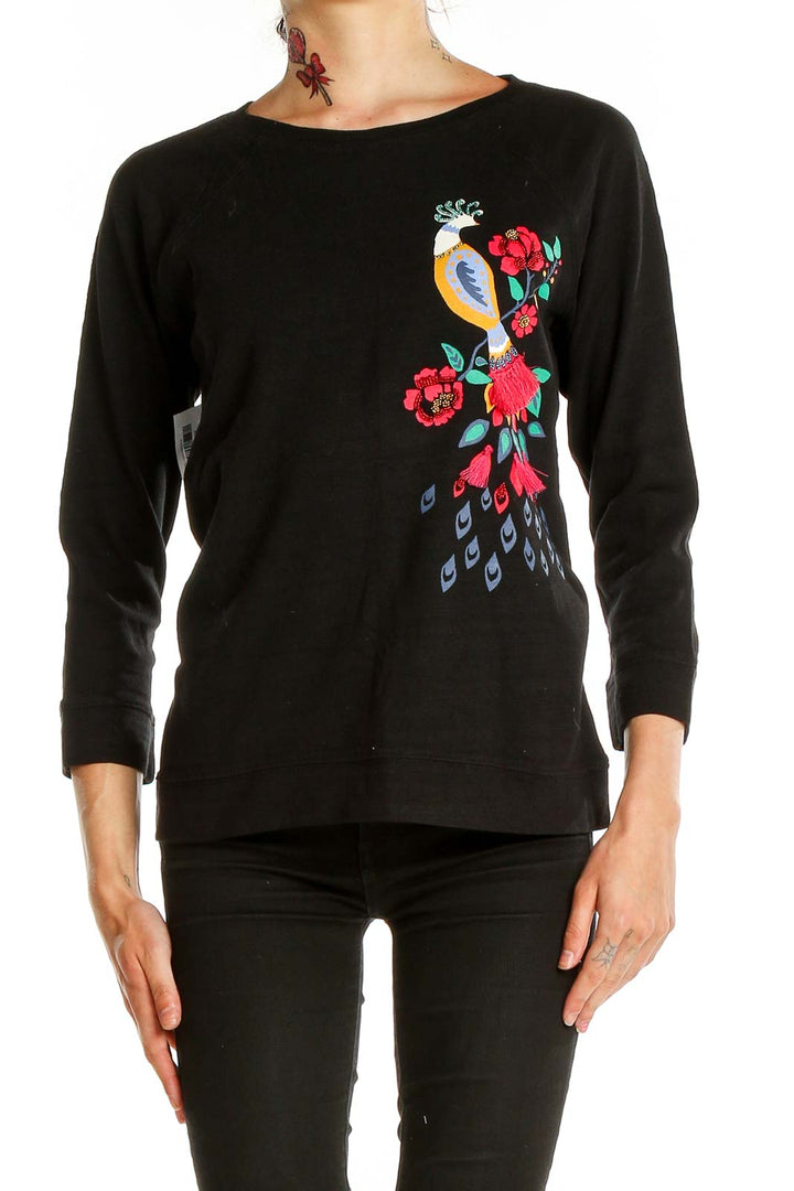 Front view of LOFT black cotton top with embroidered peacock design