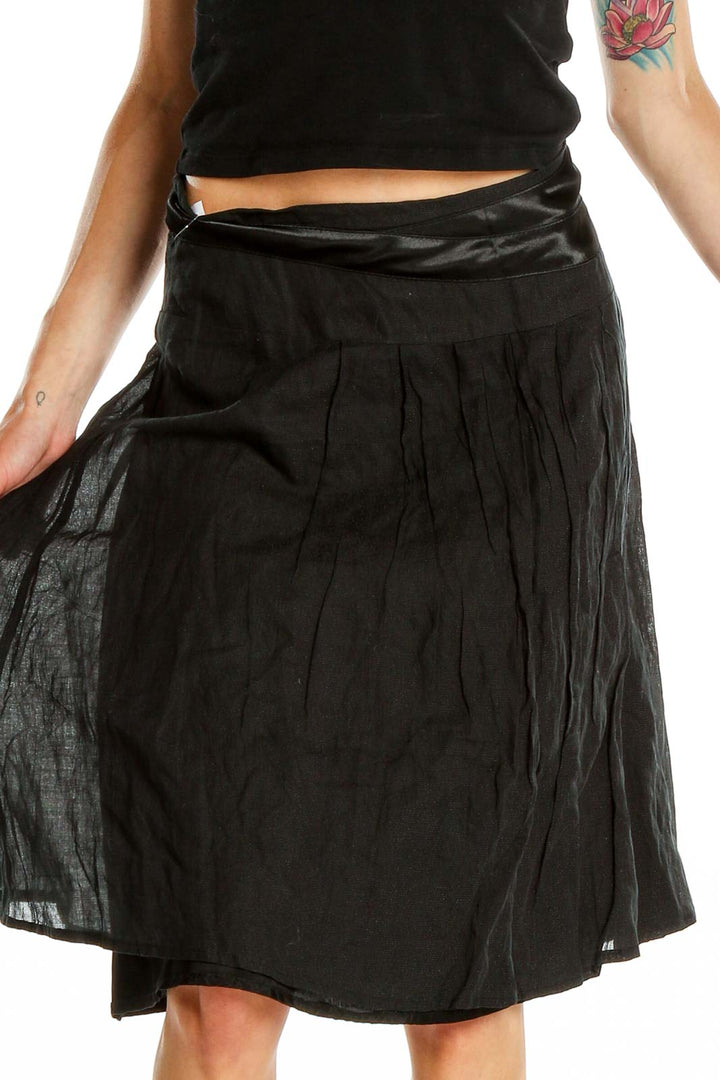 Front view of black flowy midi skirt by People Like Frank