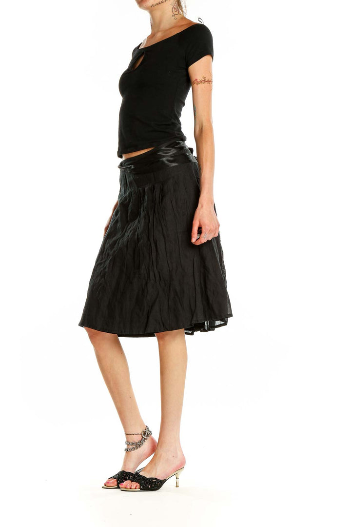 Front view of black flowy midi skirt by People Like Frank