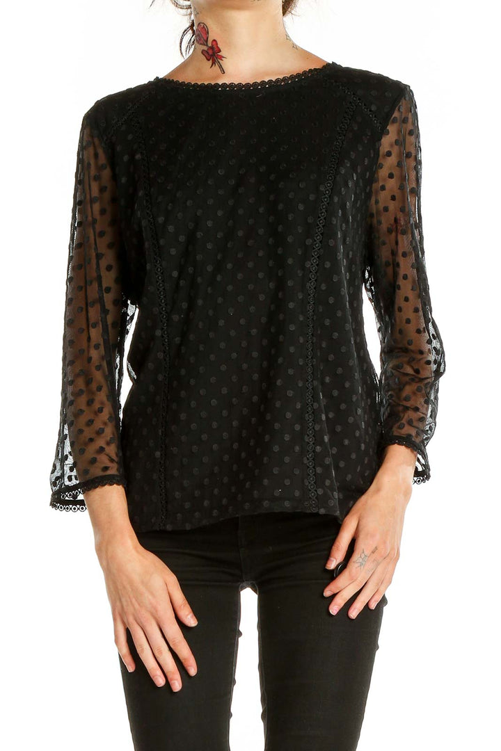 Front view of Boden black top with sheer polka dot sleeves and lace trim