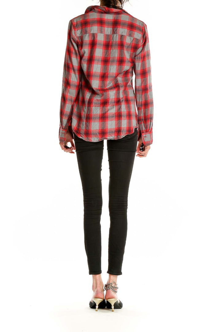 Back view of J.Crew red plaid button-down shirt on model with black pants