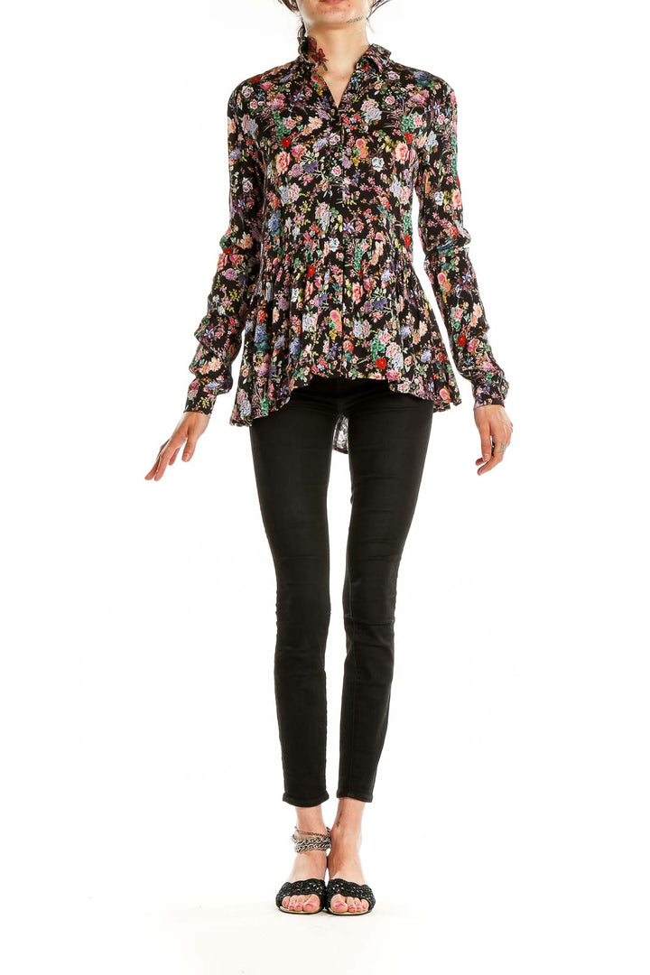 Front view of Tuckernuck black floral peplum blouse with button-up design