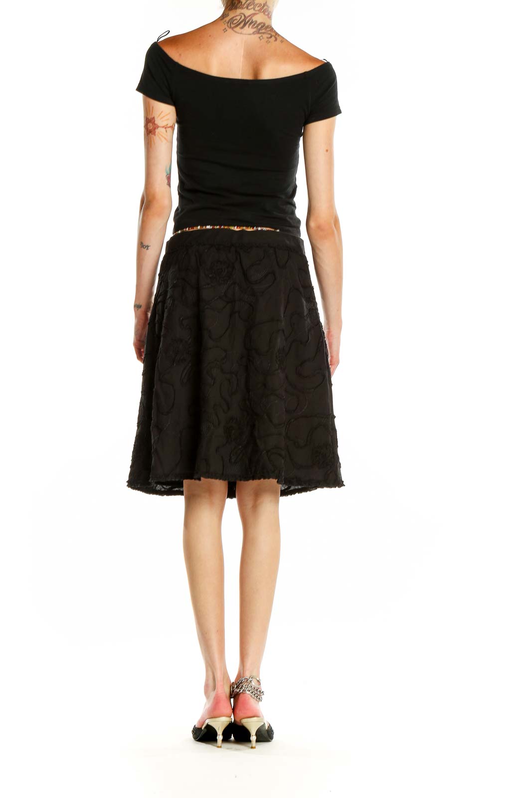 Side view of Max Studio black floral embroidered A-line skirt on model