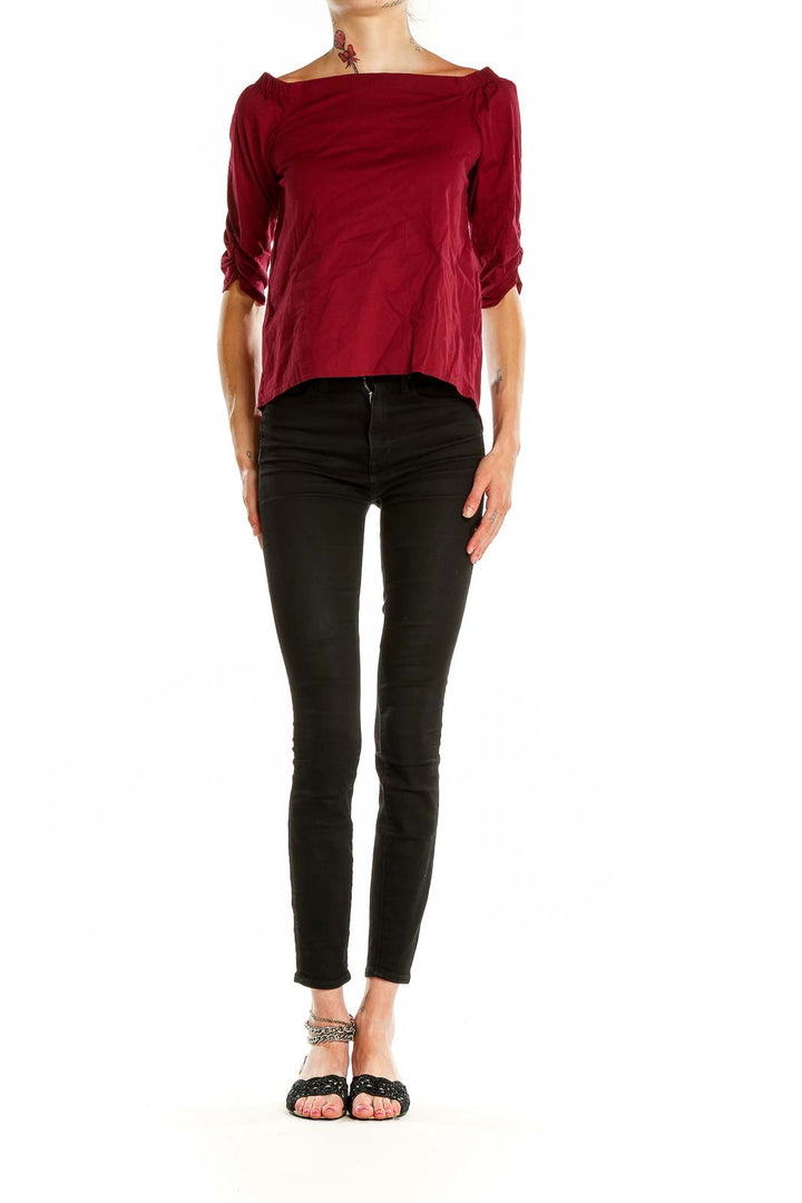 Front view of burgundy off-shoulder top with ruched sleeves