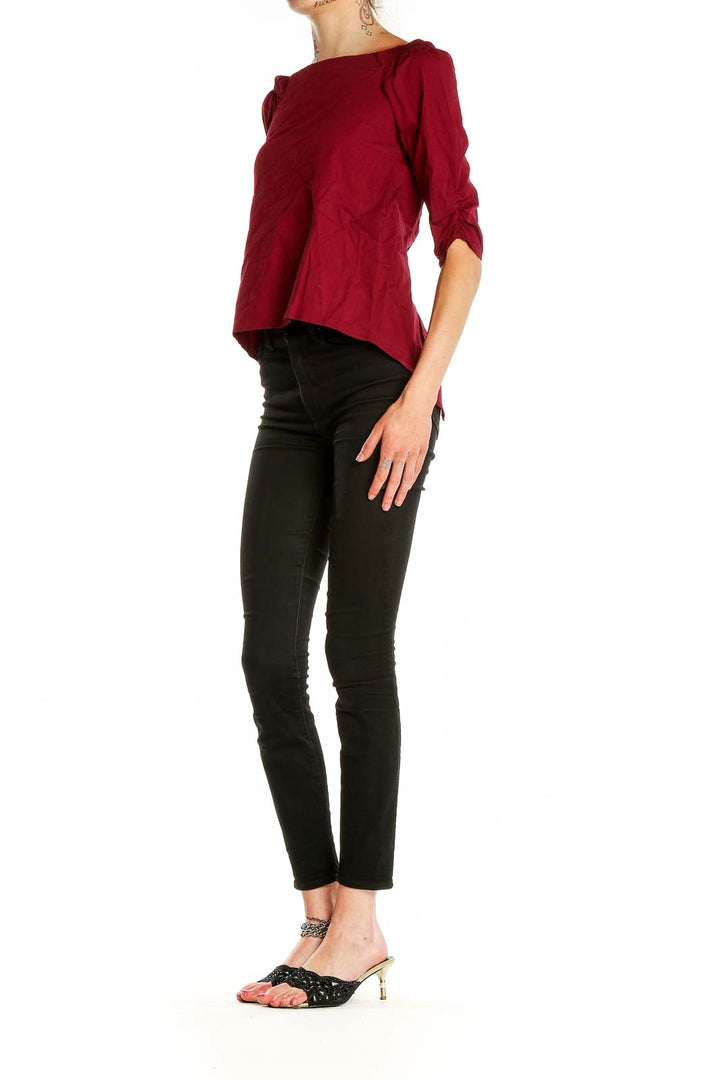 Front view of burgundy off-shoulder top with ruched sleeves