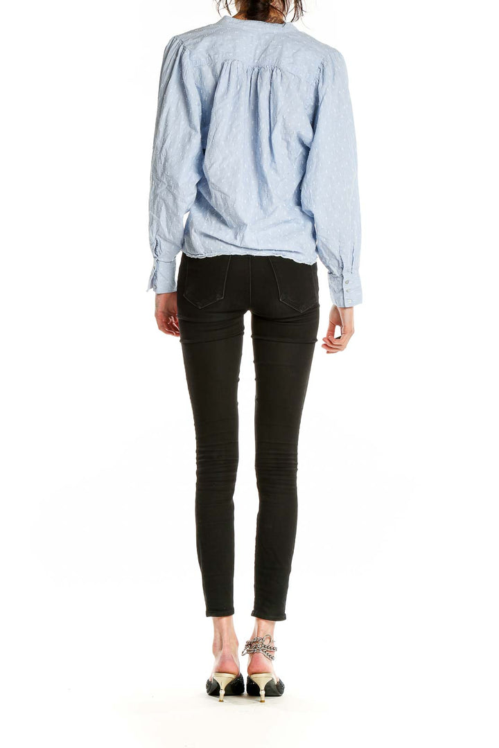 Side view of Joie light blue textured blouse showing relaxed fit and cropped length