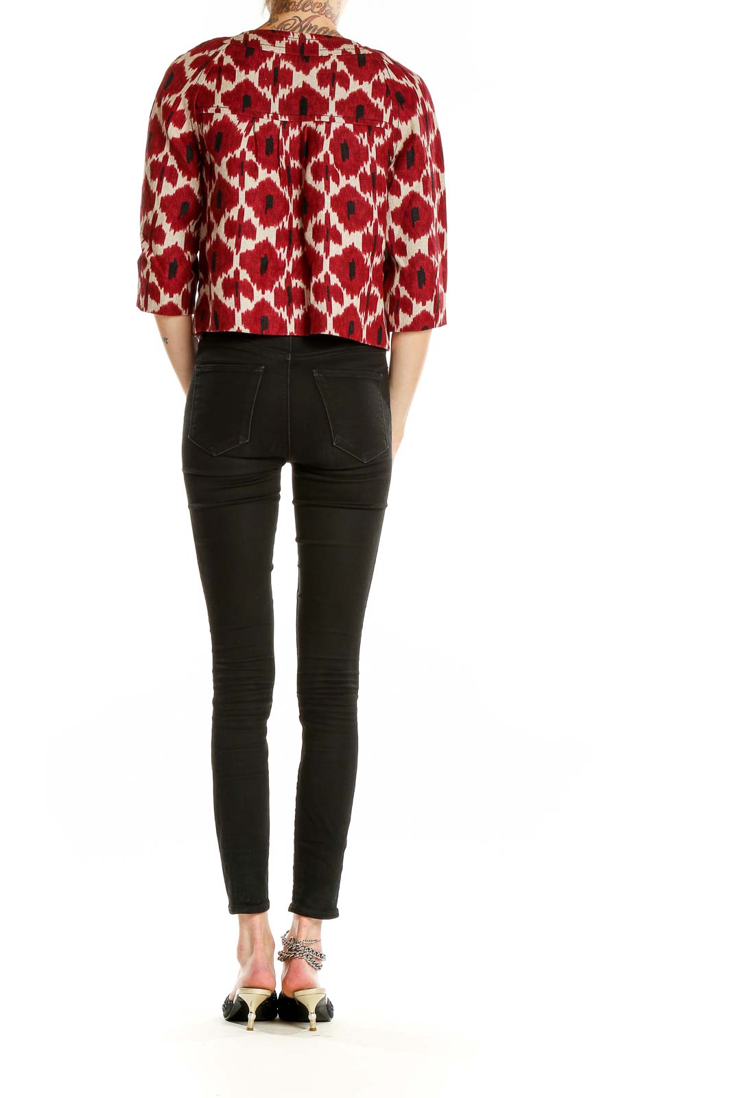 Side view of MICHAEL Michael Kors red ikat print cropped jacket paired with black pants