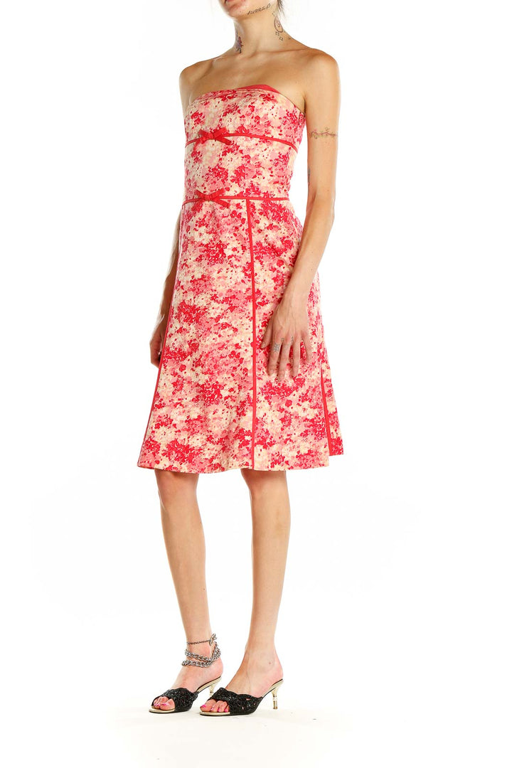 Front view of Ann Taylor pink floral strapless cocktail dress with red ribbon accents