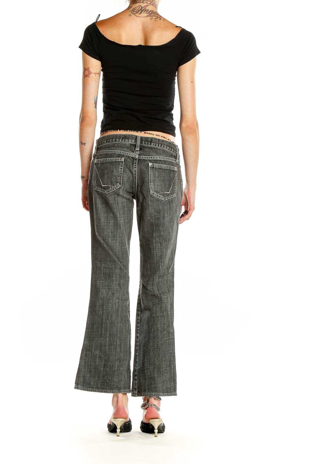 Side view of Gap gray faded wide-leg jeans on model with black top