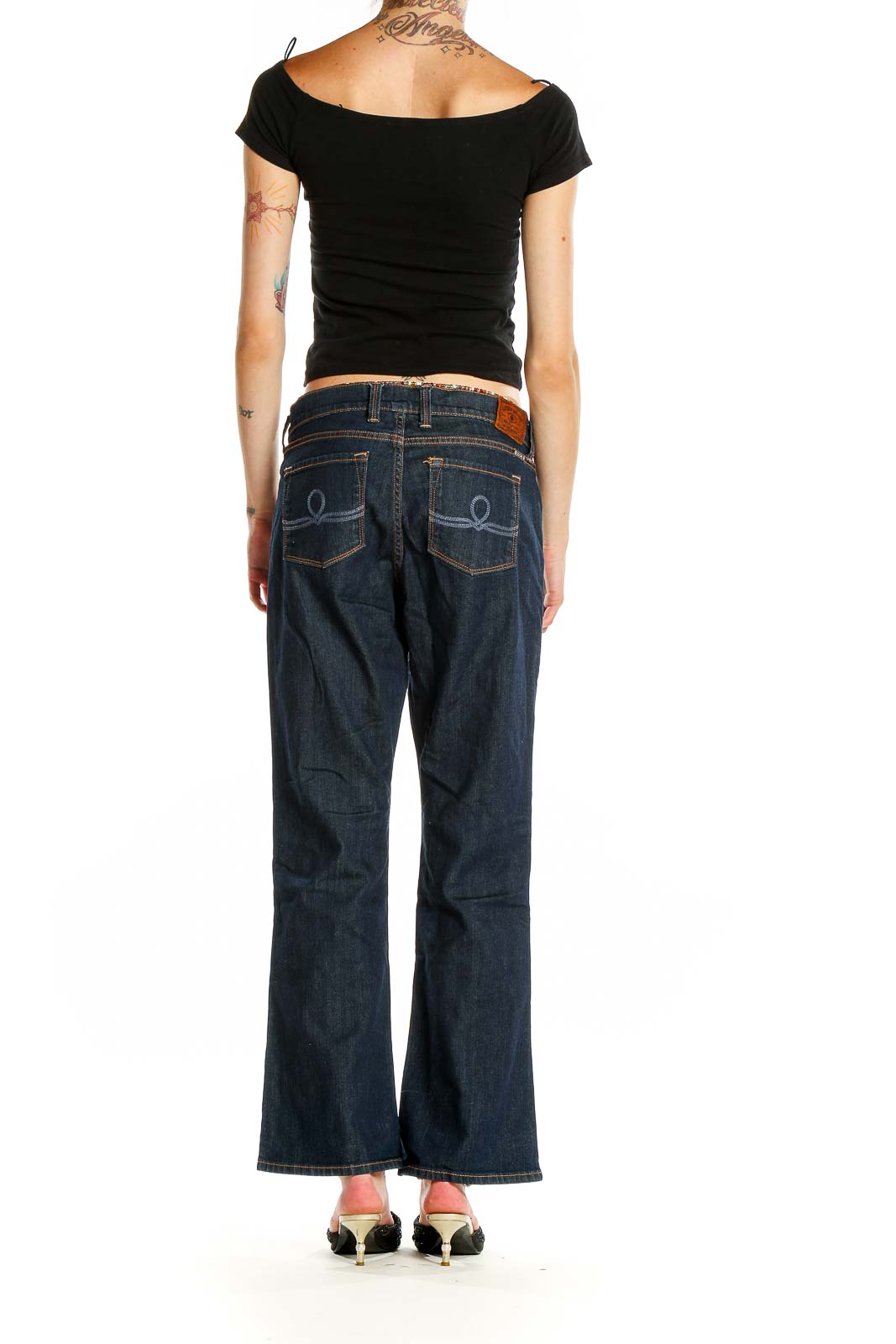 Side view of Lucky Brand dark blue bootcut jeans on model