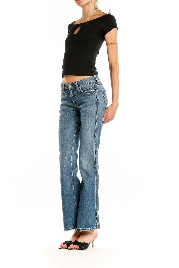 Front view of 7 For All Mankind blue flared jeans on model