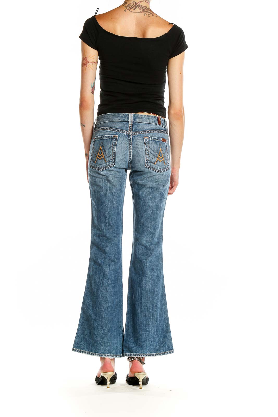 Side view of 7 For All Mankind blue flared jeans on model