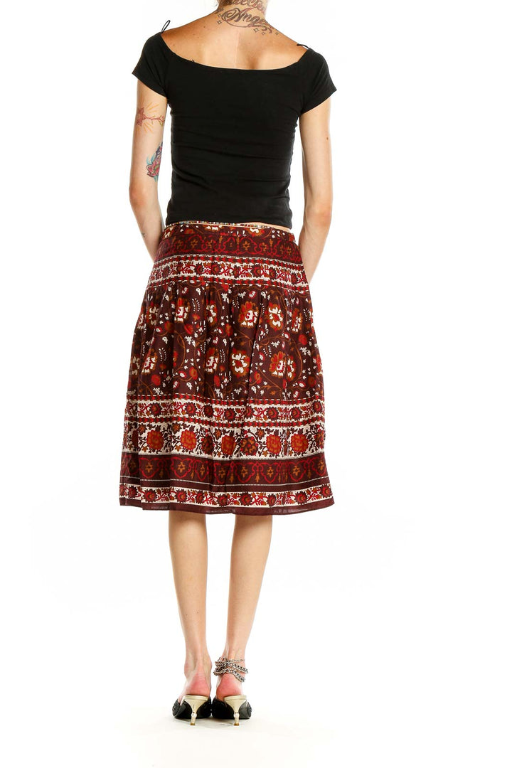 Side view of Ann Taylor brown floral print A-line midi skirt on model