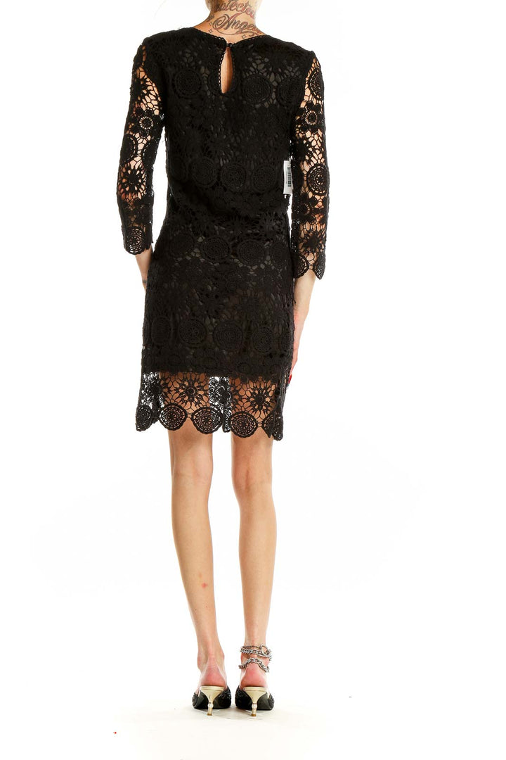 Back view of black lace crochet cocktail dress with keyhole detail