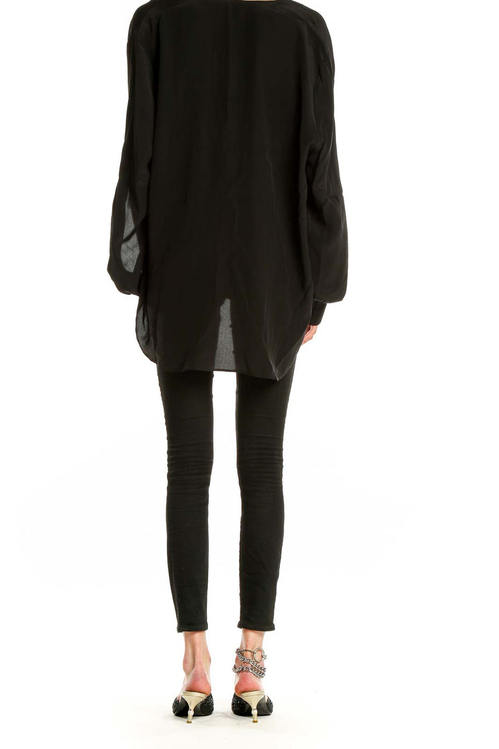 Back view of 7 For All Mankind black draped wrap blouse showing long sleeves and relaxed fit