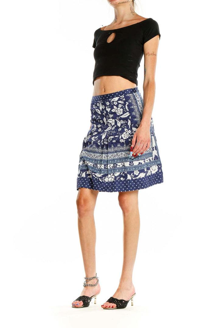 Front view of Ann Taylor LOFT navy floral print A-line skirt with polka dot hem