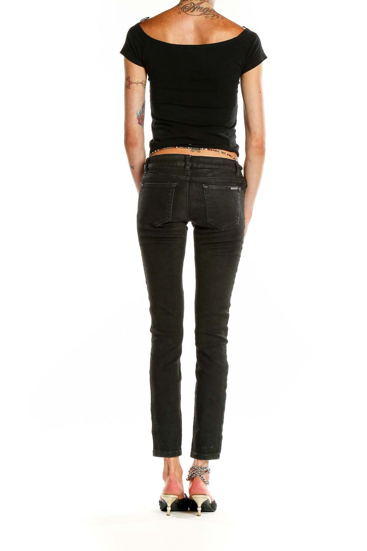 Back view of MICHAEL Michael Kors black slim-fit denim jeans on model