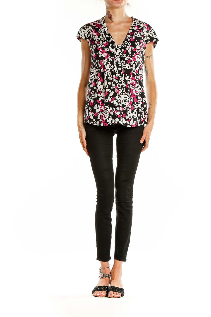 Front view of Trina Turk black floral print cap sleeve blouse