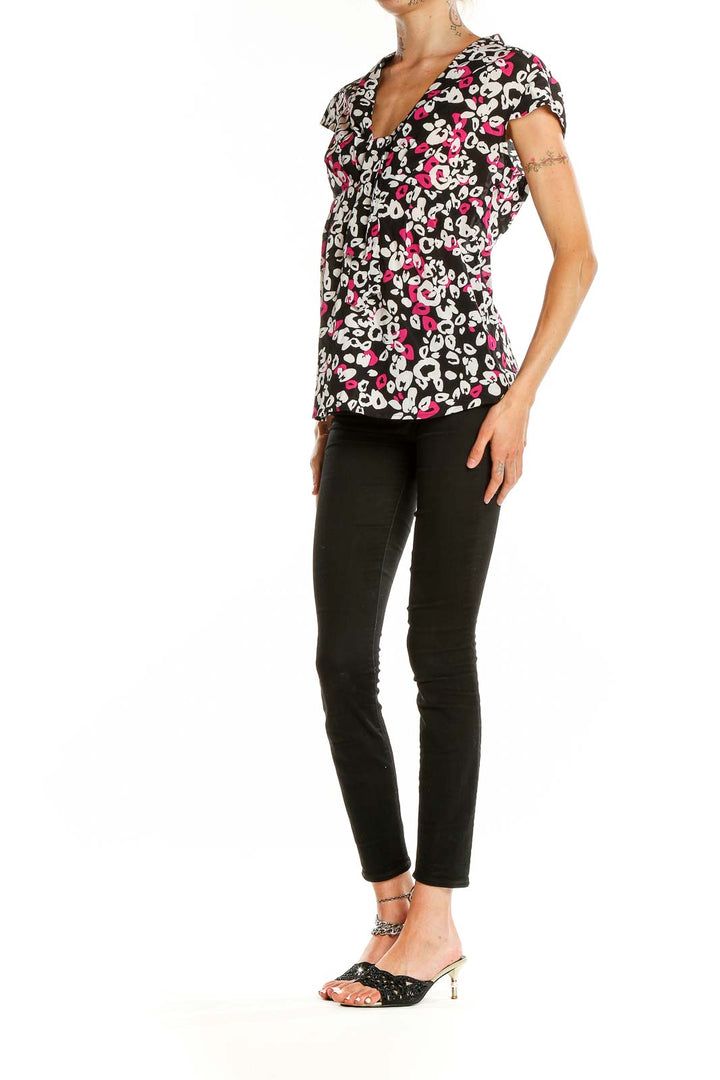 Front view of Trina Turk black floral print cap sleeve blouse