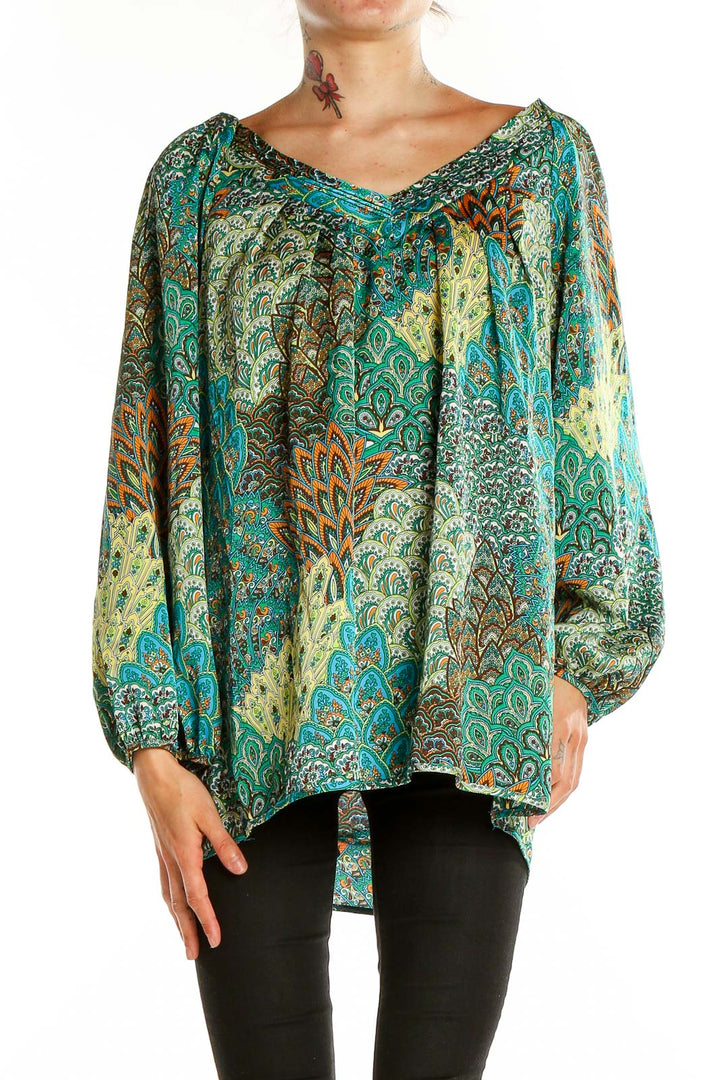 Front view of teal paisley print blouse with V-neckline and flowing sleeves