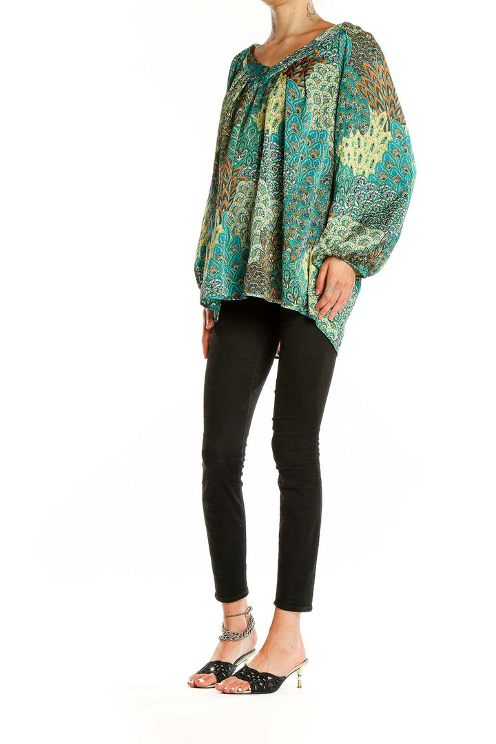 Front view of teal paisley print blouse with V-neckline and flowing sleeves