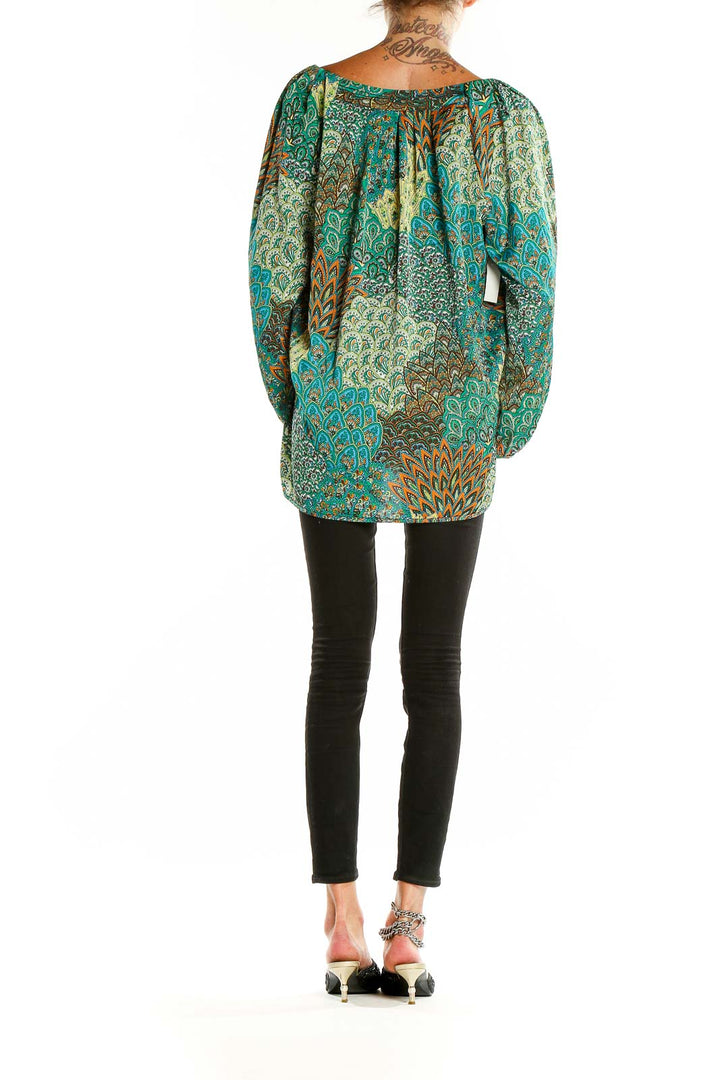 Back view of teal paisley print blouse showing relaxed fit and longer length