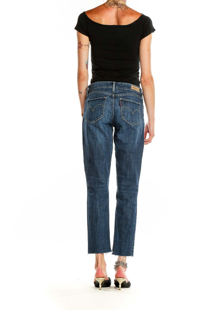 Back view of Levi's blue cropped straight-leg jeans on model