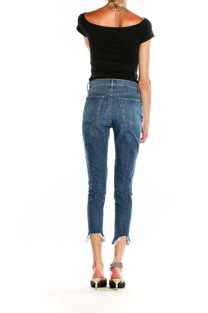 Back view of Gap blue cropped jeans showing pocket design and raw hem detail