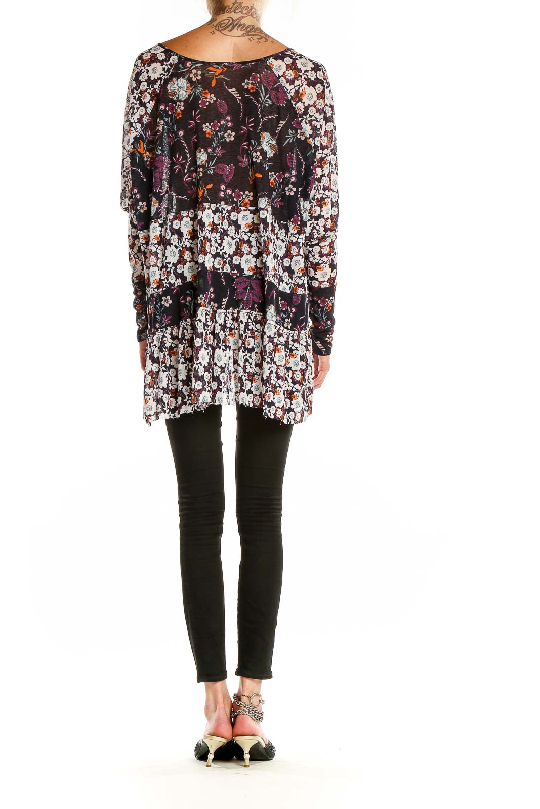 Back view of Free People multicolor floral tunic top showing paneled design